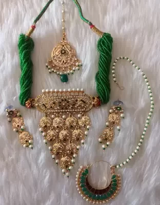beautifull jewllery set with earrings and tikka nosepin in green colour